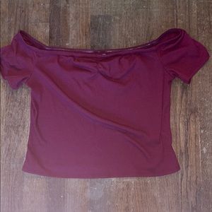 A maroon crop top, off the shoulders.